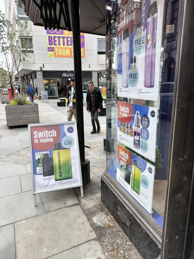 A UK vape shop with bright product displays in the window