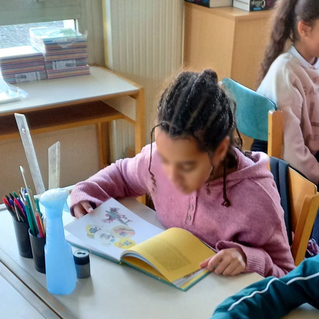Students in a classroom with smartphones put away during a lesson, illustrating a study of phone bans and academic performance